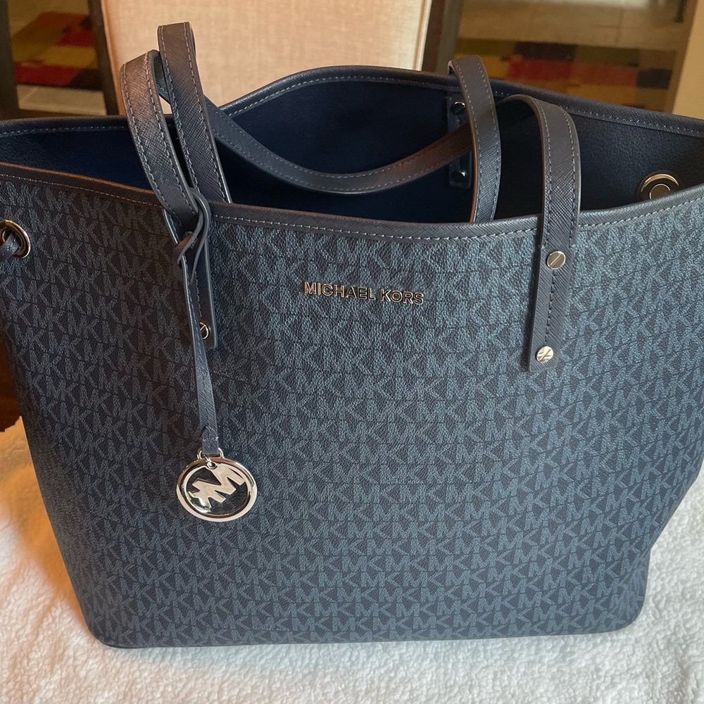 Dark blue Michael Kors reversible tote bag with wristlet.